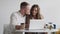 Lifestyle business couple sitting in office looking screen laptop happy working, small business