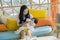 Lifestyle candid portrait of young happy and sweet Asian Korean woman feeding her beautiful baby girl with formula bottle at