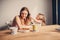 Lifestyle capture of happy mother and baby girl having breakfast at home