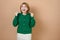 Lifestyle concept - Portrait of cheerful happy girl with joyful and exciting smiling isolated on beige background