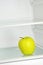 Lifestyle concept.Yellow apple in domestic refrigerator.