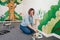 Lifestyle creative hobby and freelance artistic work side job concept. Caucasian woman artist hand painting murals on walls