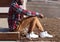 Lifestyle fashion photo stylish african man listens music enjoys sunset, wearing hipster plaid red shirt sitting in profile