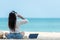 Lifestyle freelance woman listen music after using laptop working and relax on the beach.