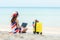 Lifestyle freelance woman using laptop working on the beach.