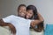 Lifestyle home portrait of young happy and successful romantic African American couple in love relaxed sitting comfortable