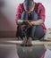Lifestyle indoors portrait of young sad and depressed black african American woman sitting at home floor feeling desperate and wor