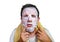 Lifestyle isolated background portrait of young weird and funny man at home trying using paper facial mask cleansing applying anti