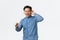Lifestyle, leisure and technology concept. Happy dancing asian man in glasses, listening music wireless headphones