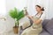 Lifestyle in living room concept, Young Asian woman in glove using cloth to wiping flower vase