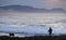 Lifestyle - a man and his dog walk on the seaside