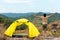 Lifestyle man travel hiker adventure and tent camping on mountain nature landscape. Young people tourist backpack raise hand