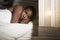 Lifestyle night portrait of young sad and stressed black african American woman lying on bed upset trying to sleep suffering insom