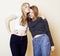 Lifestyle and people concept: Fashion portrait of two stylish girls best friends, over white background. Happy time