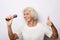 Lifestyle and people concept: Portrait of charming modern grandmother holds up the microphone