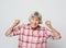 Lifestyle and people concept: portrait of a cheerful grandmother gesturing victory close up