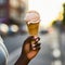 lifestyle photo hand holding an ice cream cone