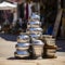 lifestyle photo iran stack of copper kettles outside shop