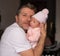 Lifestyle portrait of attractive and happy man holding his baby girl in his arms as a proud father in parenting and love concept