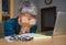 Lifestyle portrait of depressed and overworked middle aged attractive Asian woman working in stress on laptop computer desk