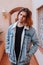 Lifestyle portrait of gen z teenage boy in denim jacket outdoors in empty street