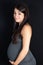 Lifestyle portrait pregnancy woman beauty under black background