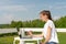 Lifestyle portrait of pretty young girl working at the laptop in the balcony of hotel in mountains. Freelance