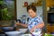 Lifestyle portrait of senior happy and sweet Asian Japanese retired woman cooking at home kitchen alone neat