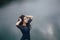 Lifestyle portrait of a woman brunette on the background of the lake in the sand on a cloudy day. Romantic, gentle, mystical