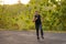 Lifestyle portrait of young attractive and healthy man on his 30s or 40s running on country road doing jogging workout training