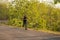 Lifestyle portrait of young attractive and healthy man on his 30s or 40s running on country road doing jogging workout training