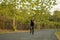 Lifestyle portrait of young attractive and healthy man on his 30s or 40s running on country road doing jogging workout training