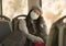 Lifestyle portrait of young attractive and pretty Asian woman wearing mask in railcar traveling in new normal virus time - sweet