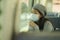 Lifestyle portrait of young attractive and pretty Asian woman wearing mask in railcar traveling in new normal virus time - sweet