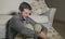 Lifestyle portrait young attractive sad and depressed man sitting on living room floor feeling desperate and stressed suffering