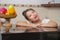 Lifestyle portrait of young beautiful and happy Asian Chinese woman posing relaxed at home kitchen smiling cheerful and sweet