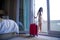 Lifestyle portrait of young happy and beautiful Asian Korean tourist woman with suitcase arriving to luxury hotel room opening bal