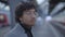 Lifestyle Portrait Of Young Man With Black Curly Hair Inside Train Station