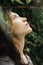 Lifestyle profile portrait of young female in green leaves