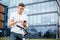 Lifestyle, transport, communication and people concept - young man with bicycle and smartphone on city street