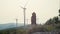 Lifestyle video of a girl in a hat walking near windmills. Renewable energy