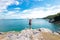 Lifestyle woman standing relax on a rock above the ocean