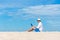 Lifestyle young asian man working on laptop while sitting chill on the beautiful beach, freelance working social on holiday summer