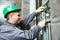 Lift machinist repairing elevator in lift shaft