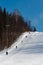 Lift for skiers and snowboarders in the winter day. Slope for skiing