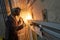 Lift worker welding elevator fasteners in lift shaft