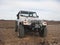 Lifted White Jeep 2002 Wrangler Parked on Dirt in Arizona Desert