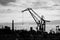 lifting crane for unloading and loading near the marina for ships in the Gulf of Finland. Black and white photo
