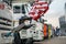 Lifting hook hanging on a cable close-up Trucks in a row as construction equipment with a crane