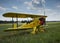 Light aircraft. Light yellow airplane on airport grass. Light general aviation plane on final